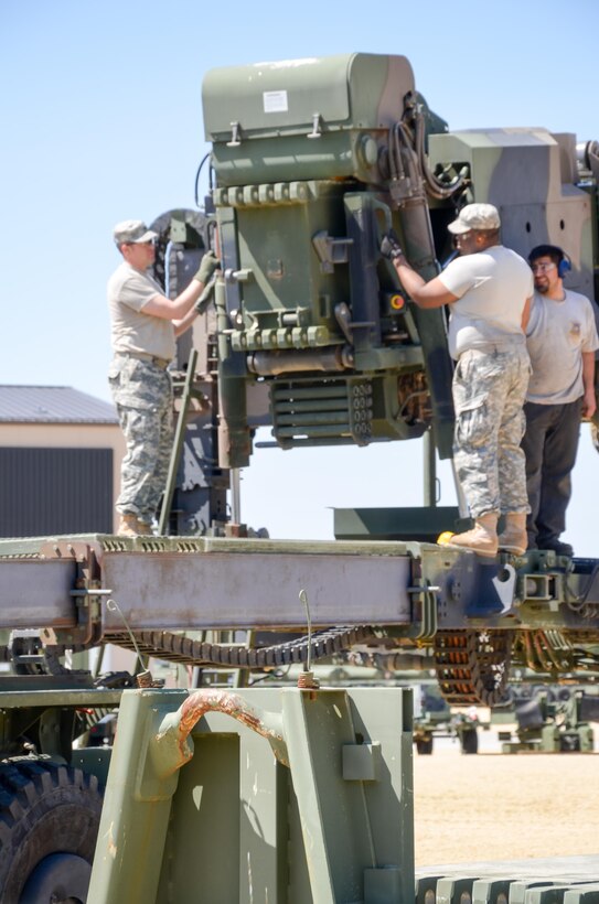 88th Regional Support Command Equipment Concentration Site - 67 personnel, Aaron White (far right) checks the assembly progress during a training exercise on the operation and maintenance of a Dry Span Support Bridge at the soon to be established Draw Yard at ECS-67 on Fort McCoy, Wis., May 5.