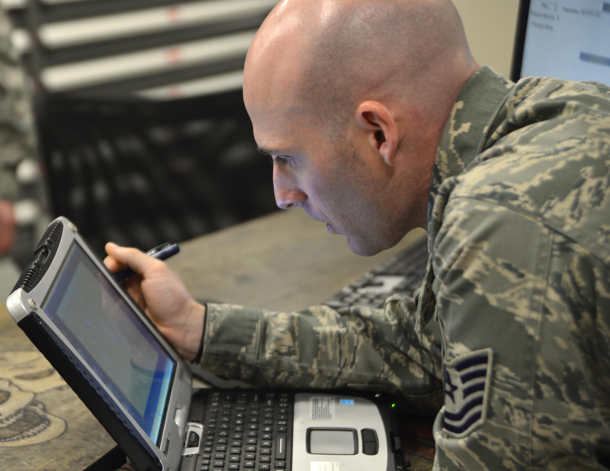 Tech. Sgt. Bryan, 432nd Maintenance Group technical order distribution office, inspects a laptop May 3, 2016, at Creech Air Force Base, Nevada. The quality assurance shop inspects all maintenance including weapons, munitions, support, crew chiefs, avionics, and ground control stations. (U.S. Air Force photo by Senior Airman Christian Clausen/Released)