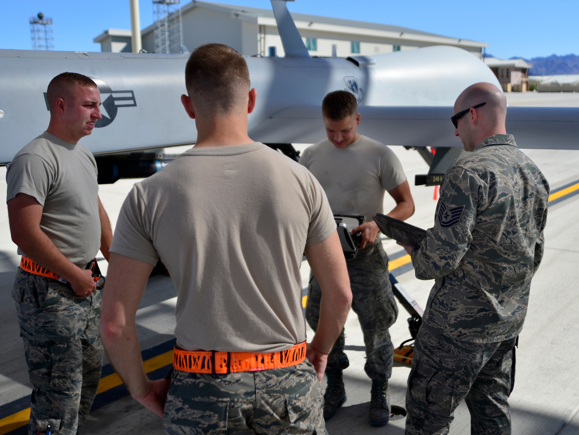 Tech. Sgt. Bryan, 432nd Maintenance Group technical order distribution office, gets maintenance identification numbers from a 432nd Aircraft Maintenance Squadron Tiger Aircraft Maintenance Unit team May 3, 2016. The crew completed a brake adjustment while Bryan inspected the process. (U.S. Air Force photo by Senior Airman Christian Clausen/Released)