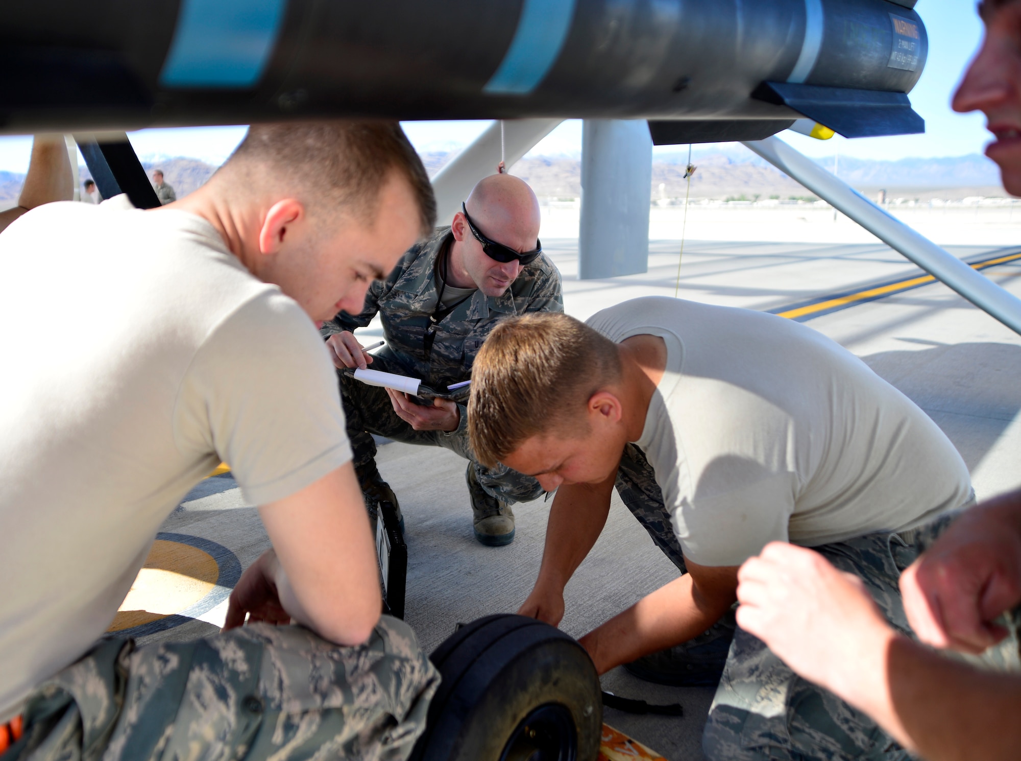 Tech. Sgt. Bryan, 432nd Maintenance Group technical order distribution office specialist, watches as a 432nd Aircraft Maintenance Squadron Tiger Aircraft Maintenance Unit team completes a brake adjustment on an MQ-1 Predator May 3, 2016. Bryan is a member of the 432nd MXG quality assurance shop which ensures the quality of maintenance performed on the MQ-1 Predator and MQ-9 Reaper. (U.S. Air Force photo by Senior Airman Christian Clausen/Released)