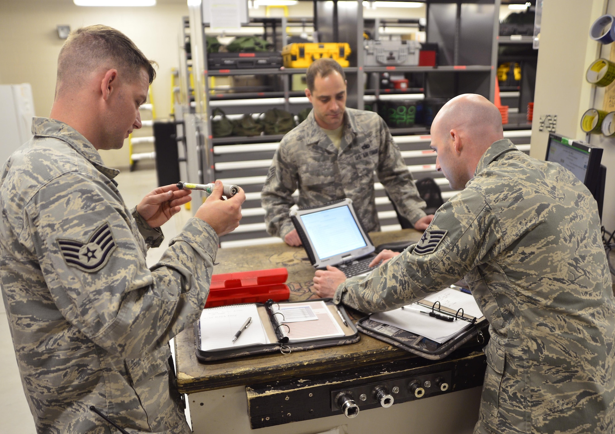 Staff Sgt. Ron, 432nd Maintenance Group quality assurance inspector, left, and Tech. Sgt. Bryan, 432nd Maintenance Group technical order distribution office, right, inspect a torque wrench and laptop May 3, 2016. QA inspects every aspect of maintenance performed on MQ-1 Predators and MQ-9 Reapers including the support shops to ensure Airmen have the right tools to complete the mission. (U.S. Air Force photo by Senior Airman Christian Clausen/Released)