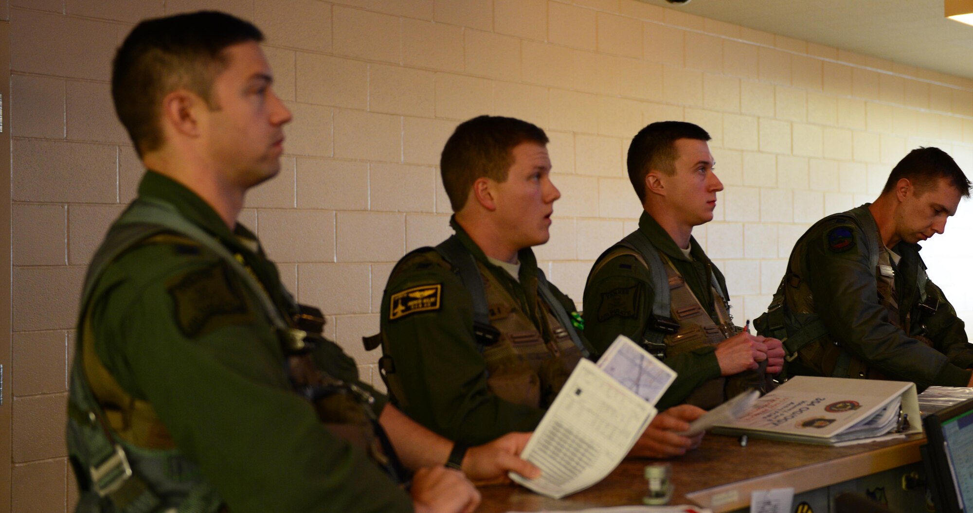 U.S. Air Force 1st Lt. Jacob “Hobs” Houder, a pilot assigned to the 80th Fighter Squadron, Kunsan Air Base, Republic of Korea, listens to the flight de-brief May 5, 2016, at Eielson Air Force Base, Alaska. Houder is participating in his first RED FLAG-Alaska exercise; a series of Pacific Air Forces commander-directed field training exercises. (U.S. Air Force photo by Airman 1st Class Cassandra Whitman/Released)