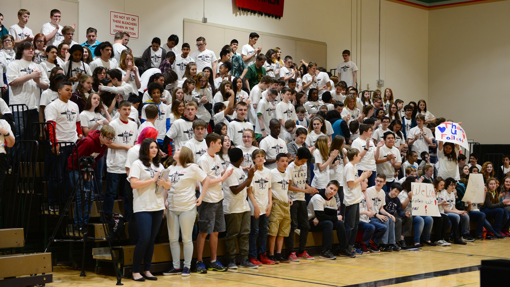 Ben Eielson High School students cheer as they are presented a big check for $60,000 May 6, 2016, at Eielson Air Force Base, Alaska. BEHS won the 5th Annual Follett Challenge after submitting a video showcasing its innovative STEM program. (U.S. Air Force photo by Airman 1st Class Cassandra Whitman/Released)