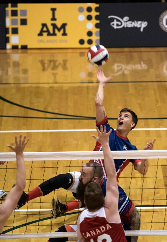 Army veteran Nicholas Titman returns the ball against the Canadian team during a sitting volleyball match at the 2016 Invictus Games in Orlando, Fla., May 7, 2016. DoD photo by Roger Wollenberg