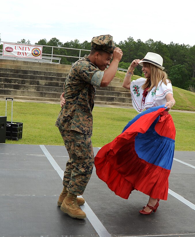 Cpl. Peter Hernandez-fuentes, adjutant clerk, Marine Corps Logistics Command, dances with Lydia Olds, Spanish teacher, International Studies Elementary School, Albany, Ga., during the annual Unity Day celebration held recently on Marine Corps Logistics Base Albany. The event is held to educate individuals on diversity and celebrate differences.