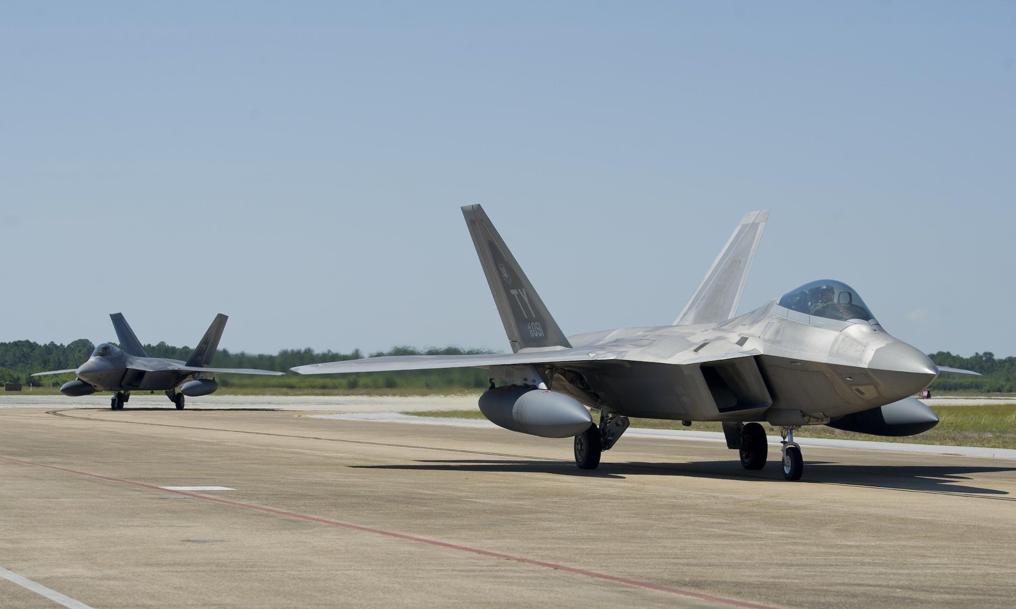 Two 95th Fighter Squadron F-22 Raptors taxi on the flightline after returning from a deployment to Europe May 8, 2016, at Tyndall AFB. While in Europe, the F-22s traveled to Royal Air Force Lakenheath, England; Mihail Kogalniceanu Air Base, Romania; and Šiauliai Air Base, Lithuania. (U.S. Air Force photo by Senior Airman Alex Fox Echols III/Released)