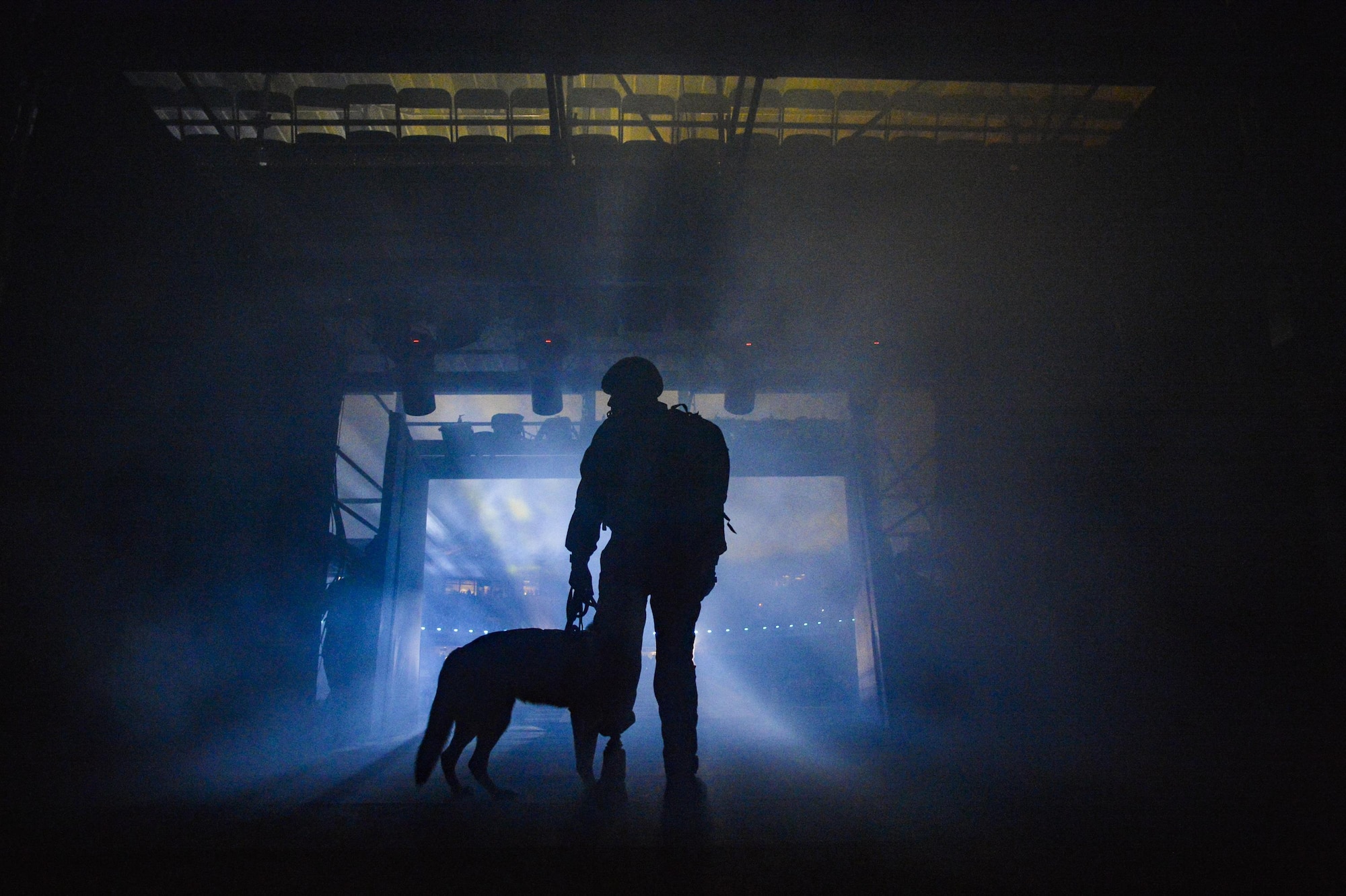 Staff Sgt. August O'Neill and his service dog, Kai, prepare to enter the stadium at ESPN Wide World of Sports Complex for the Invictus Games 2016 opening ceremony in Orlando, Fla., May 8, 2016. O'Neill delivered the Invictus Games flag after hoisting down from an HH-60G Pave Hawk. (U.S. Air Force Photo/Tech. Sgt. Joshua L. DeMotts)