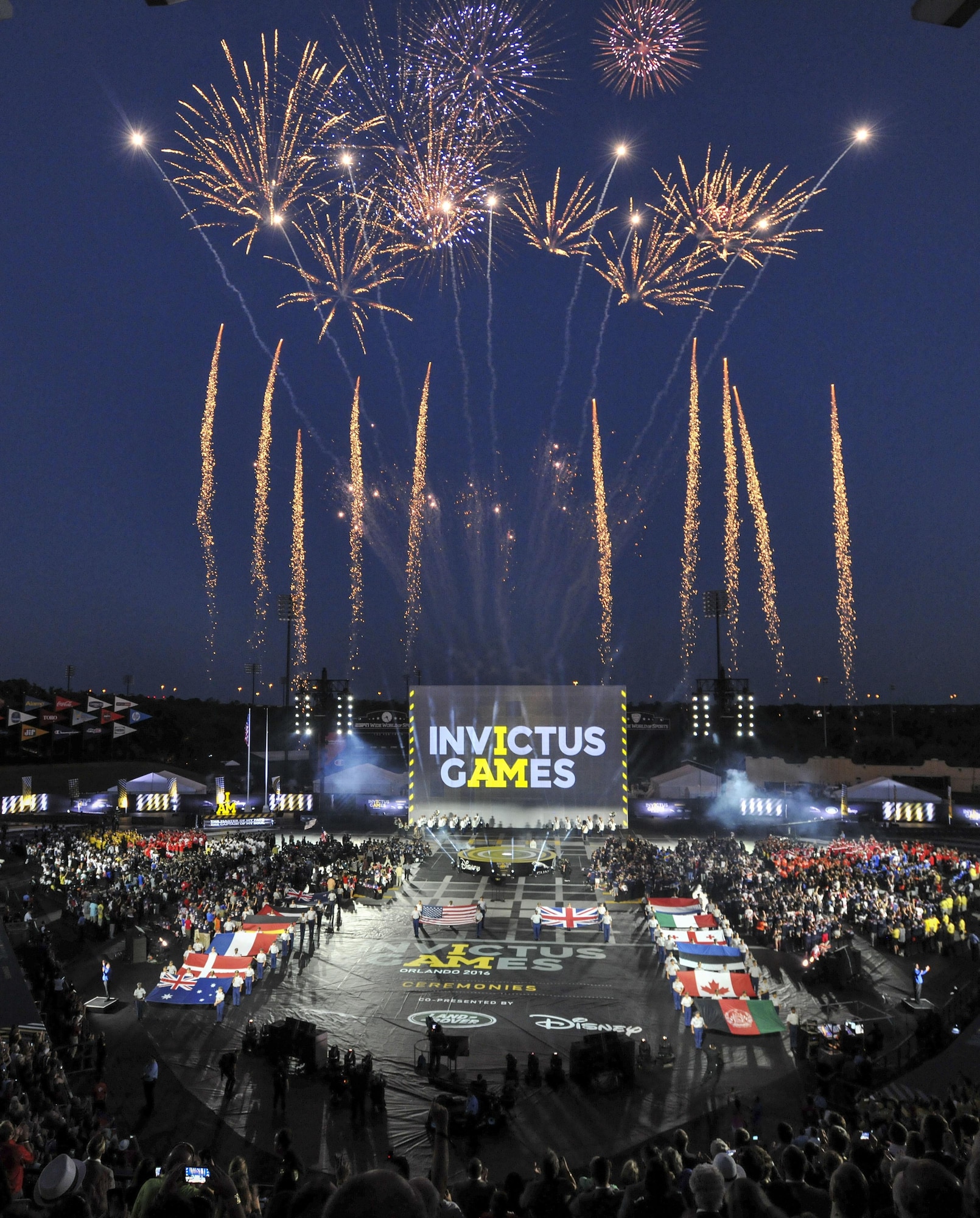 Fireworks erupt as the flags of 15 nations are displayed during the opening ceremony for Invictus Games 2016 at the ESPN Wide World of Sports Complex in Orlando, Fla., May 8, 2016. The 2016 Invictus Games officially kicked off with the ceremony and wounded warriors will compete over the next five days in multiple adaptive sports events. (U.S. Air Force photo/Senior Master Sgt. Kevin Wallace) 