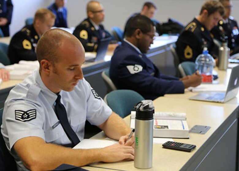 Tech. Sgt. Joseph Merfeld takes notes while attending class at George Mason, as part of the Enlisted to Medical Degree Preparatory Program. The Enlisted to Medical Degree Preparatory Program is a partnership between the Armed Services and Uniformed Services University. Designed for enlisted service members, the two-year program enables members to remain on active duty status while enrolled as full-time students in preparation for application to medical school. (Courtesy photo)