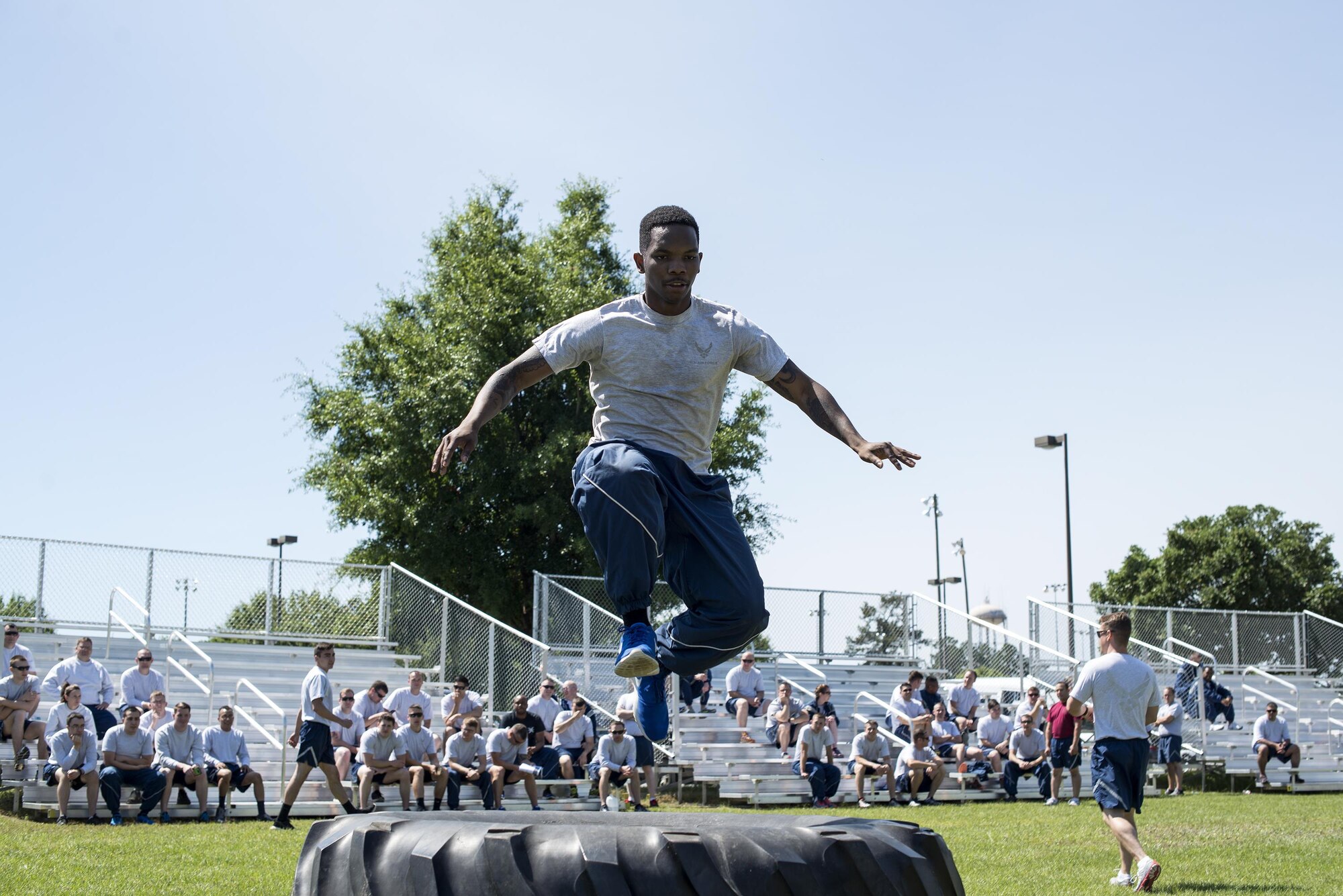 U.S. Air Force Senior Airman Roderick Rodgers, 23d Equipment Maintenance Squadron aircraft structural maintainer, jumps over a tire, May 6, 2016, at Moody Air Force Base, Ga.  During this obstacle course, Airmen had to run through and over a tire, sprint with heavy brief cases, and toss a beanbag into a corn hole before the next member of their team could go. (U.S. Air Force photo by Airman 1st Class Janiqua P. Robinson/Released)