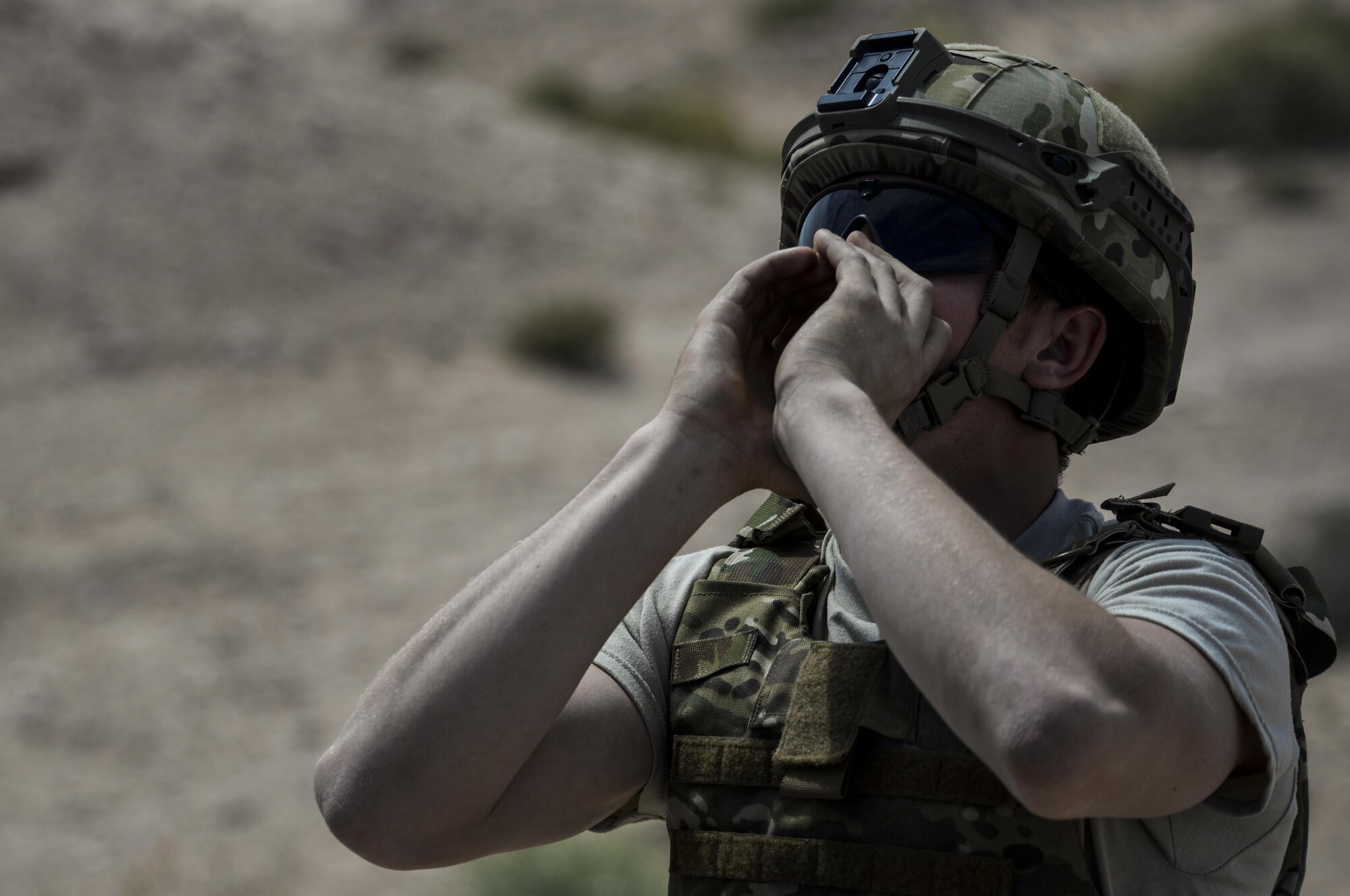 Senior Airman Kyle Osgood, 99th Civil Engineer Squadron explosive ordinance technician, calls out to signal that the range is hot during a training exercise at Nellis Air Force Base, Nev. May 5, 2016. EOD technicians’ conduct long range and close in reconnaissance, identify and assesses ordnance condition and advise commanders on recommended safe withdrawal distances. (U.S. Air Force photo by Airman 1st Class Kevin Tanenbaum)