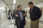John Grimes, a naval architect with the Center for Innovation in Ship Design (Code 8202), presents the Indicative Ship Design project to Capt. Mark Vandroff, prospective commanding officer of Naval Surface Warfare Center, Carderock Division, during the Naval
Innovative Science and Engineering/Section 219 Expo at the Pentagon April 21. (U.S. Navy photo by Monica McCoy/Released)
