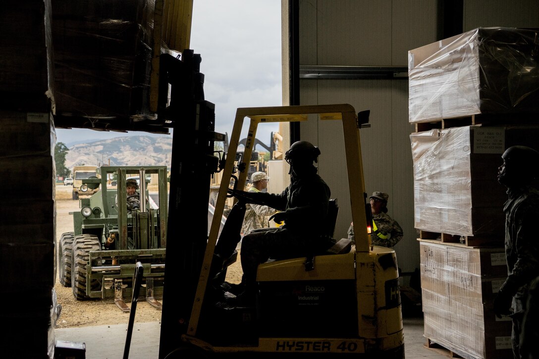 A Soldier from the 693rd Quartermaster Company, Bell, Calif., pulls a palate of rations in a warehouse at Fort Hunter Liggett, Calif. for transfer to Soldiers training in the field. The annual Warrior Exercise is designed for units to practice technical skills in a tactical environment under simulated combat conditions.