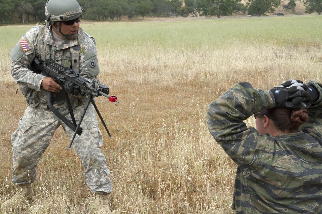 U.S. Army Spc. Adan Garcia, 238th Transportation Company (TC) from Concord, Calif. guards a member of the opposing forces during a training mission on Fort Hunter Liggett, Calif. on May 7, 2016. Garcia's unit became under fire while establishing a Tactical Assembly Area during the WAREX event hosted by 91st Training division, and maintained security as they detained the enemy. (U.S. Army photo by Spc. Sean McCallon, 91st Training Division public affairs.)