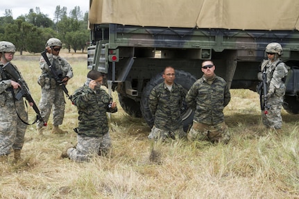 U.S. Army Soldiers from the 422nd Military Police (MP) Company are detained by Soldiers of the 238th Transportation Company (TC), while acting as opposing forces during the WAREX event hosted by 91st Training division on Fort Hunter Liggett, Calif. on May 7, 2016. The 238th TC was conducting an exercise to establish a Tactical Assembly Area, when they were attacked by opposing forces, played by Soldiers from the 422nd MP Co., who were captured and detained. (U.S. Army photo by Spc. Sean McCallon, 91st Training Division public affairs.)