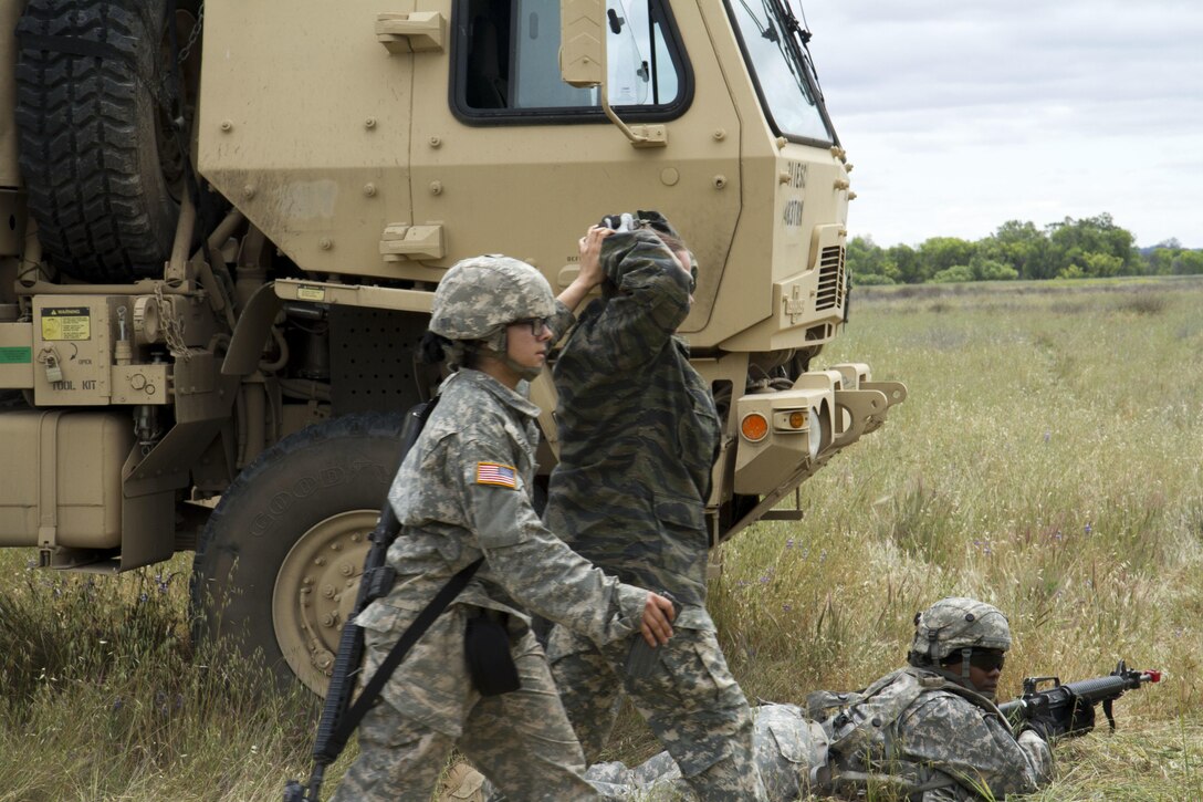 U.S. Army Spc. Sandra Gomez, 238th Transportation Company (TC) from Concord, Calif. escorts a captured enemy soldier during her unit's exercise as part of the WAREX event hosted by the 91st Training Division. The 238th TC was tasked with establishing a Tactical Assembly Area, when they became under fire by opposing forces, but were able to defend and capture the enemy. (U.S. Army photo by Spc. Sean McCallon, 91st Training Division public affairs.)