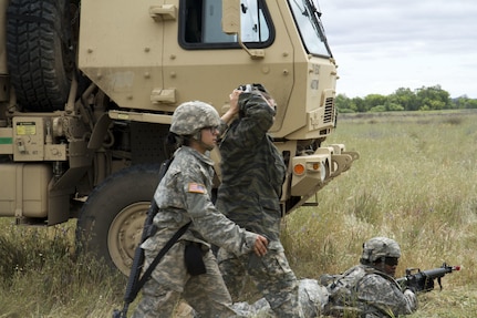 U.S. Army Spc. Sandra Gomez, 238th Transportation Company (TC) from Concord, Calif. escorts a captured enemy soldier during her unit's exercise as part of the WAREX event hosted by the 91st Training Division. The 238th TC was tasked with establishing a Tactical Assembly Area, when they became under fire by opposing forces, but were able to defend and capture the enemy. (U.S. Army photo by Spc. Sean McCallon, 91st Training Division public affairs.)