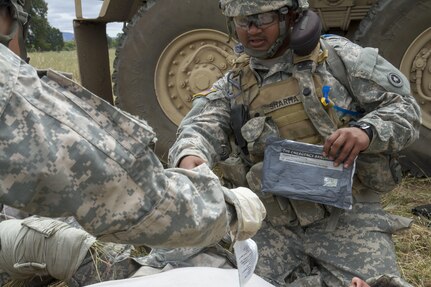 U.S. Army Spc. Kavinesh Sharma, 238th Transportation Company (TC) from Concord, Calif. renders medical aid to a casualty while participating in a training exercise during the WAREX events hosted by the 91st Training Division on Fort Hunter Liggett, Calif. on May 7, 2016. Sharma got to practice identifying and treating a casualty under enemy fire while his unit established a Tactical Assembly Area. (U.S. Army photo by Spc. Sean McCallon, 91st Training Division public affairs.)