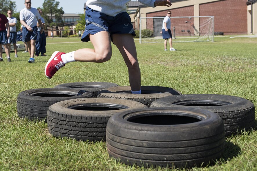 A U.S. Air Force Airman runs through tires during an obstacle course, May 6, 2016, at Moody Air Force Base, Ga. Airmen split into teams of four to compete in this challenge. (U.S. Air Force photo by Airman 1st Class Janiqua P. Robinson/Released)