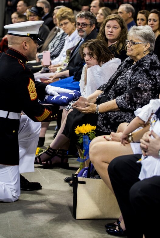 1st Sgt. Joshua A. Peterson, Inspector-Instructor first sergeant, Company D, 4th Law Enforcement Battalion, Force Headquarters Group, Marine Forces Reserve, presents the flag to former U.S. Senator Conrad Burns’ wife during the memorial service at MetraPark’s Rimrock Auto Arena, May 6, 2016. Burns served in the Marine Corps from 1955-1957 and also served as a U.S. Senator from 1989- 2007. Marine Forces Reserve performed 91 percent of all funeral honors rendered by the Marine Corps in calendar year 2015 and continues to provide timely and professional support to veterans. (U.S. Marine Corps photo by Lance Cpl. Melissa Martens/ Released) 