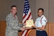 U.S. Air Force Col. Michael Grunwald Jr., 17th Training Group Commander, presents the 315th Training Squadron Enlisted Student of the Month award for April 2016 to Airman 1st Class Alicia Harris in Brandenburg Hall on Goodfellow Air Force Base, Texas, May 6, 2016. (U.S. Air Force photo by Staff Sgt. Laura R. McFarlane/Released)