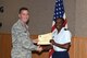U.S. Air Force Col. Michael Grunwald Jr., 17th Training Group Commander, presents the 315th Training Squadron Officer Student of the Month award for April 2016 to 2nd Lt. Courtney Waters in Brandenburg Hall on Goodfellow Air Force Base, Texas, May 6, 2016. (U.S. Air Force photo by Staff Sgt. Laura R. McFarlane/Released)
