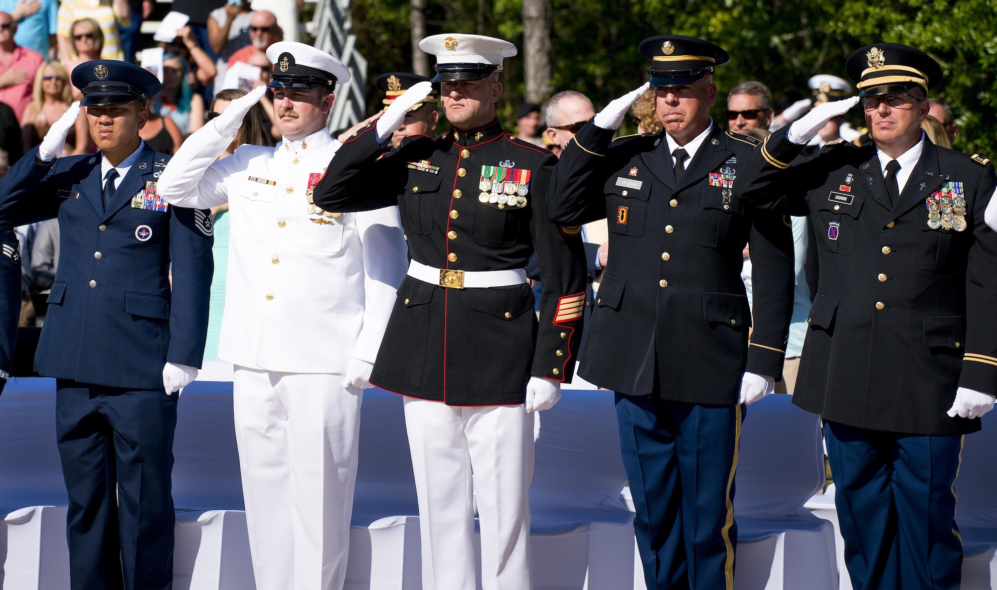 Airmen, Sailors, Marines, and Soldiers salute during the presentation of the colors at the 47th annual Explosive Ordnance Disposal Memorial Service at the Kauffman EOD Training Complex on Eglin Air Force Base, Fla., May 7, 2016. Names of recent and past fallen EOD technicians are added to the memorial wall during a ceremony each year. The Army, Marines and Navy added six new names this year. The total now stands at 320. (U.S. Air Force photo/Samuel King Jr.)