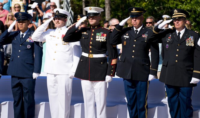 Airmen, Sailors, Marines, and Soldiers salute during the presentation of the colors at the 47th annual Explosive Ordnance Disposal Memorial Service at the Kauffman EOD Training Complex on Eglin Air Force Base, Fla., May 7, 2016. Names of recent and past fallen EOD technicians are added to the memorial wall during a ceremony each year. The Army, Marines and Navy added six new names this year. The total now stands at 320. (U.S. Air Force photo/Samuel King Jr.)