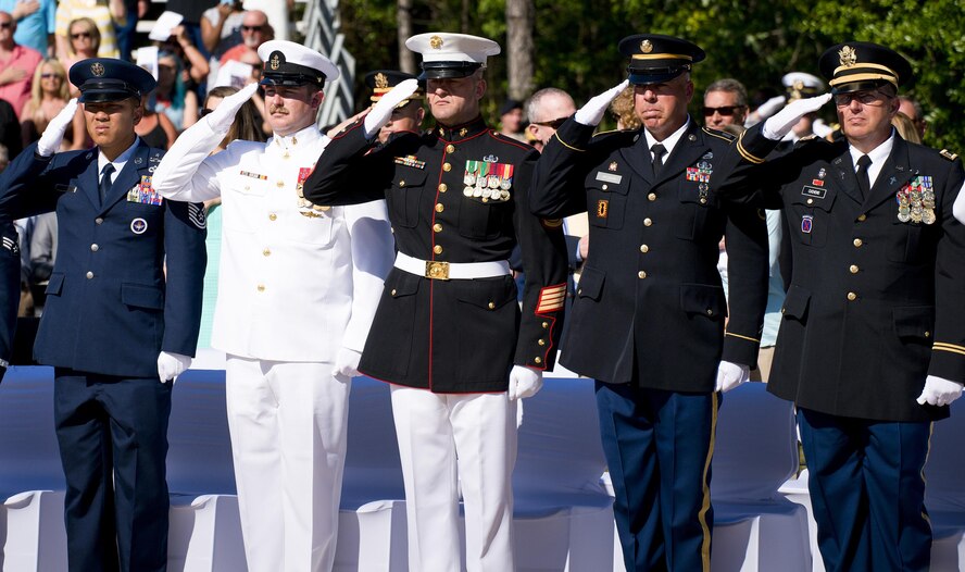 Airmen, Sailors, Marines, and Soldiers salute during the presentation of the colors at the 47th annual Explosive Ordnance Disposal Memorial Service at the Kauffman EOD Training Complex on Eglin Air Force Base, Fla., May 7, 2016. Names of recent and past fallen EOD technicians are added to the memorial wall during a ceremony each year. The Army, Marines and Navy added six new names this year. The total now stands at 320. (U.S. Air Force photo/Samuel King Jr.)