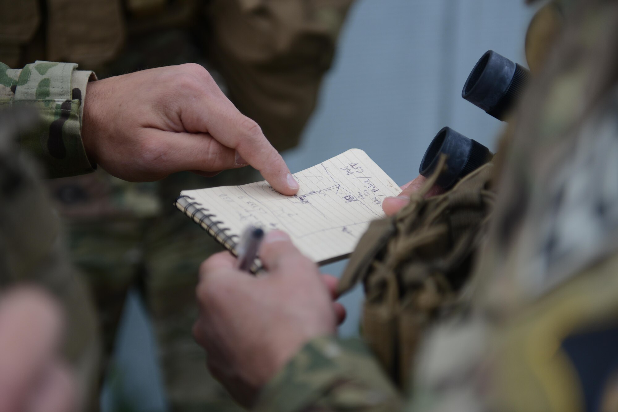 Explosive ordnance disposal technicians discuss a plan to enter an abandoned structure May 5th, 2016, at Clear Lake, California. The EOD technicians were participating in Operation: Half-Life, an exercise designed to evaluate a synchronized, multi-agency response to a crisis situation. (U.S. Air Force photo by Senior Airman Bobby Cummings)