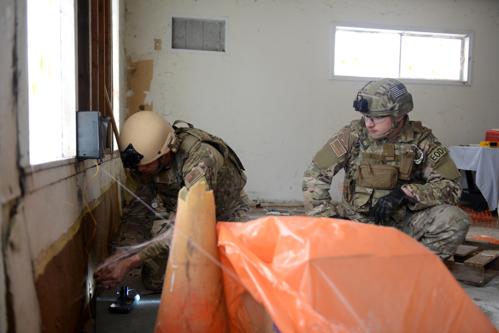 Staff Sgt. David Dezwaan (left), and Airman 1st Class Alex Nona, 60th Civil Engineer Squadron explosive ordnance disposal technicians, diffuse a simulated improvised explosive device May 5th, 2016, at Clear Lake, California. Dezwaan and Nona were participating in Operation: Half-Life, an exercise designed to evaluate a synchronized, multi-agency response to a crisis situation. (U.S. Air Force photo by Senior Airman Bobby Cummings)