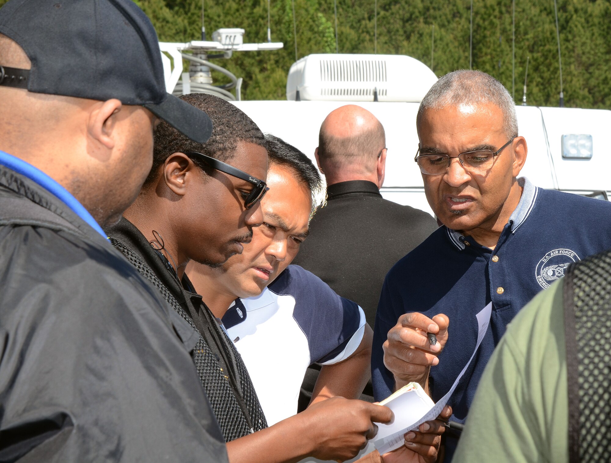 Mobile Communication Vehicle Exercise Team 3 members, John Jones, from the Atlanta Police Department Emergency Management Unit, Tech. Sgt. Stephen Athey, from the 94th Communications Squadron, and Conrad Pedersen from the 94th Mission Support Group, Emergency Management Unit, review exercise input during the 2016 Statewide Mobile Communication Vehicle (MCV) Functional Field Exercise (FFX) held at Stone Mountain State Park, Stone Mountain, Ga. May 2-6, 2016. The exercise presents a series of catastrophe type scenarios testing critical communication and coordination between MCV emergency response agencies from around the State of Georgia. (U.S. Air Force photo/Don Peek)