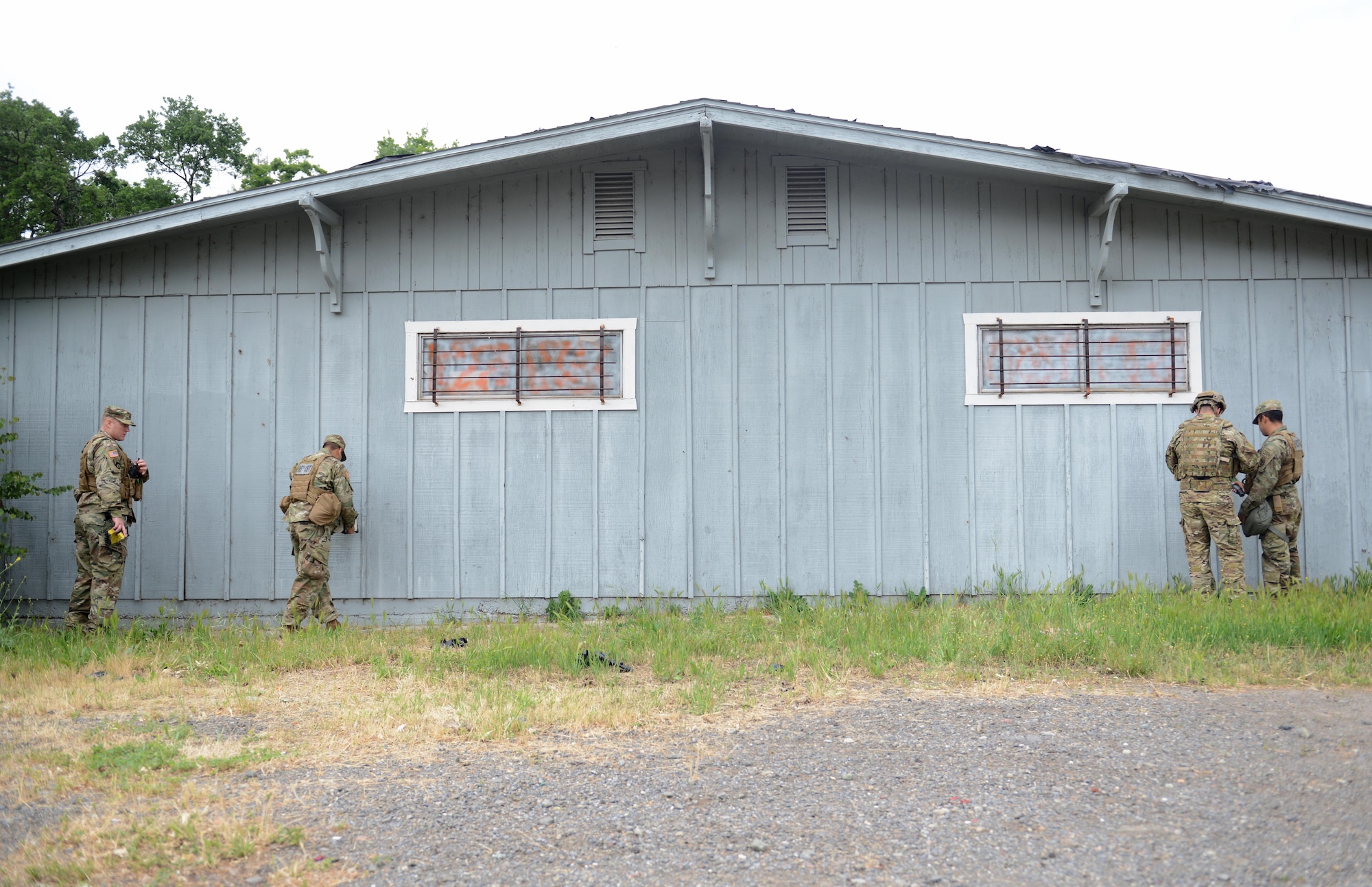 Soldiers with the 95th Civil Support Team inspect an abandoned building for radiological material May 5th, 2016, at Clear Lake, California. The building was a simulated “bomb factory” during an exercise designed to evaluate a synchronized, multi-agency response to a crisis situation. (U.S. Air Force photo by Senior Airman Bobby Cummings)