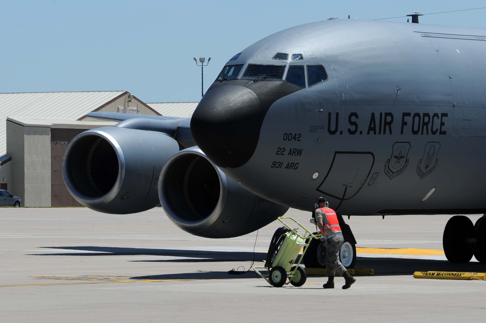 A maintenance Airmen pushes a tank up to a KC-135 Stratotanker, May 5, 2016, at McConnell Air Force Base, Kan. The KC-135’s primary mission is aerial refueling, which enhances the Air Force's capability to accomplish the primary mission of global reach. (U.S. Air Force photos/Airman 1st Class Jenna K. Caldwell)