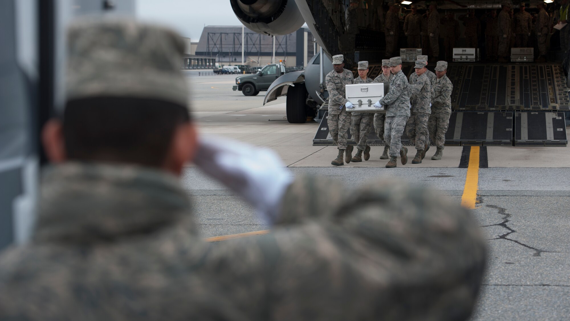 A U.S. Air Force carry team carries an empty transfer case at the Folded Flag 2016 mass fatality dignified transfer exercise May 4, 2016, at Dover Air Force Base, Del. Seven empty transfer cases were offloaded from a C-17A Globemaster III to simulate a realistic dignified transfer. (U.S. Air Force photo/Senior Airman Zachary Cacicia)