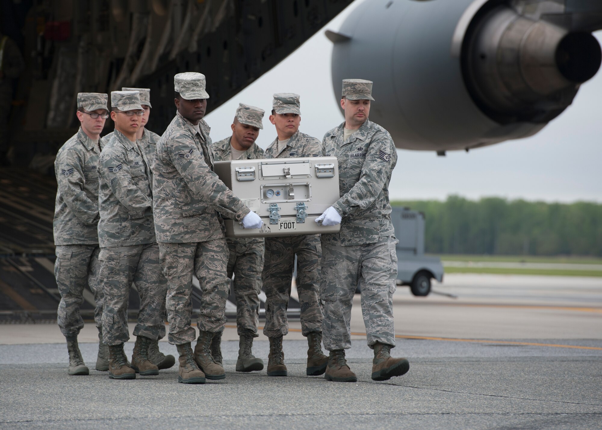 A U.S. Air Force carry team carries an empty transfer case at the Folded Flag 2016 mass fatality dignified transfer exercise May 4, 2016, at Dover Air Force Base, Del. This carry team was comprised of Airmen who are currently deployed to the Air Force Mortuary Affairs Operations. (U.S. Air Force photo/Senior Airman Zachary Cacicia)