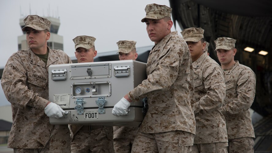 A U.S. Marine Corps carry team carries an empty transfer case at the Folded Flag 2016 mass fatality dignified transfer exercise May 4, 2016, at Dover Air Force Base, Del. Two Marine Corps and one Air Force carry teams participated in this exercise. (U.S. Air Force photo/Senior Airman Zachary Cacicia)