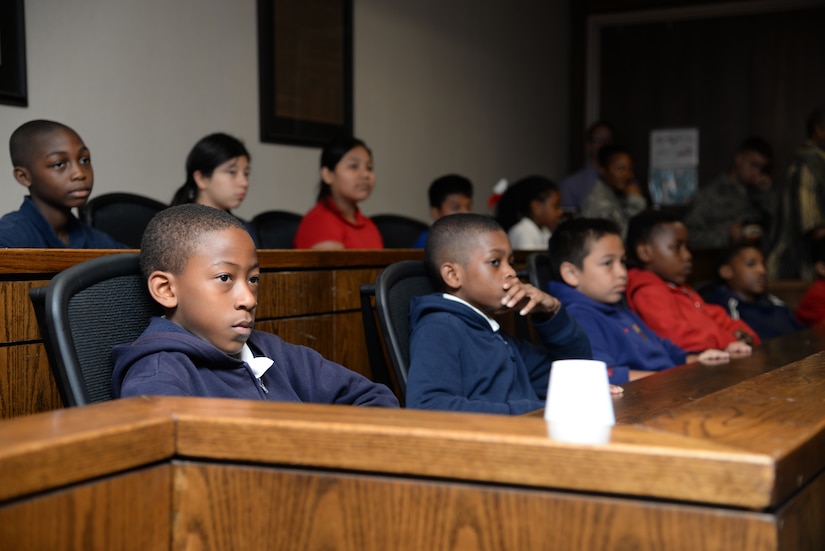 Jury members listen to arguments by the prosecution during a mock court-martial, U.S. versus Cruella Deville May 3, 2016, at Joint Base Charleston, S.C. Students from Lambs Elementary acted as jurors, lawyers and bailiff during the mock trial. This was the second year that the JB Charleston legal team opened their courtroom doors for students to learn the military legal process in celebration of Law Day.