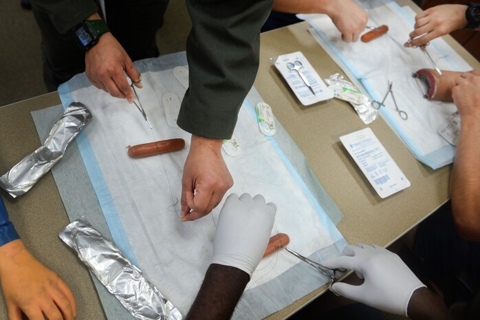 Participants in the 2016 Lowcountry Skills Fair learn how to sutra shut wounds May 4, 2016 at Joint Base Charleston - Weapons Station, S.C. The fair was created to showcase and improve the skillset of medical professionals throughout the local area. (U.S. Air Force photo/Senior Airman Ericka Engblom)