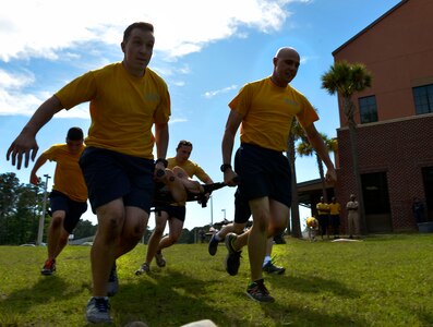 Sailors from the Naval Health Clinic Charleston carry a stretcher during the 2016 LowCountry Skills Fair, May 4, 2016, at Joint Base Charleston - Naval Weapons Station, S.C. Medical personnel from the NHCC, Shaw Air Force Base, 628th Medical Group and local community came together for a one-day skills fair, which included hands-on demonstrations, an Olympic relay race and a trophy presentation. (U.S. Air Force photo by Staff Sgt. Michael Battles)