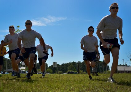 Airmen from the 628th Medical Group run a relay during the 2016 LowCountry Skills Fair, May 4, 2016, at Joint Base Charleston - Weapons Station, S.C. Medical personnel from the Naval Health Clinic Charleston, Shaw Air Force Base, 628th Medical Group and local community came together for a one-day skills fair, which included hands-on demonstrations, an Olympic relay race and a trophy presentation. (U.S. Air Force photo by Staff Sgt. Michael Battles)