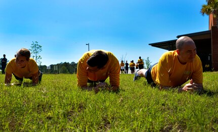 Sailors from the Naval Health Clinic Charleston perform planks during the 2016 LowCountry Skills Fair, May 4, 2016, at Joint Base Charleston - Naval Weapons Station, S.C. Participants of the skills fair included Sailors from NHCC, Airmen from the 628th Medical Group and Shaw Air Force Base and civilians from local community hospitals. (U.S. Air Force photo by Staff Sgt. Michael Battles)