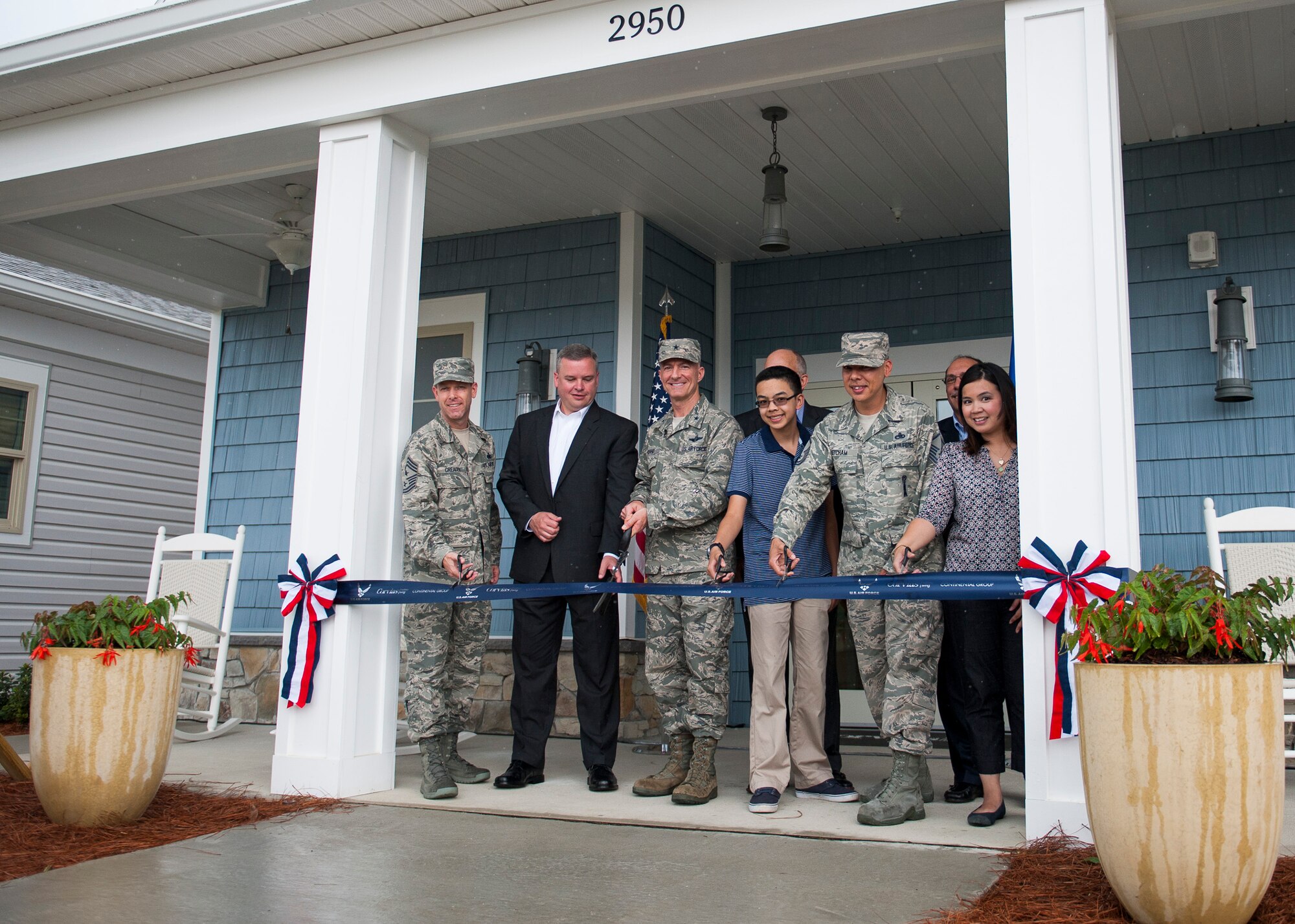 Brig. Gen. Christopher Azzano, 96th Test Wing commander, and Chief Master Sgt. Bryan Creager, 96th TW  command chief, join Corvias Military Living personnel to cut the ribbon at the grand opening of the first 747 new homes and Warrior Landing Community Center May 3 at Eglin Air Force Base, Fla. The 12,000 square foot facility features a club room, fitness center, children’s play area, gym, yoga studio and an outdoor entertainment area with a pool. (U.S. Air Force photo/Ilka Cole)  
