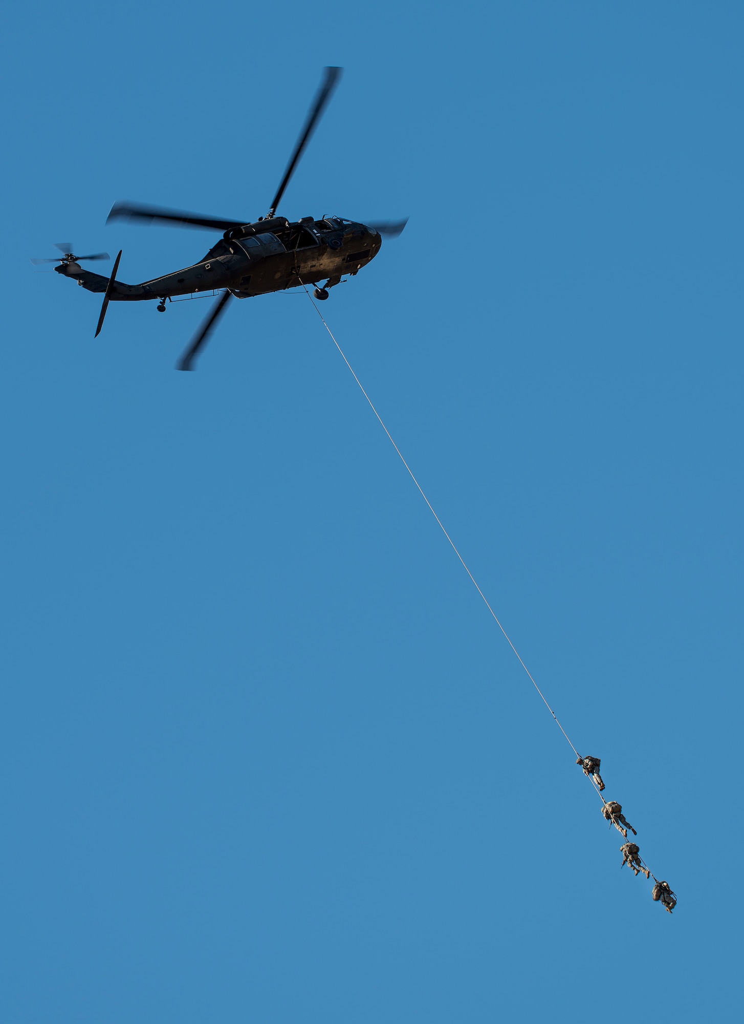 Rangers dangle from a Blackhawk helicopter via rope for a quick exit during a demonstration at the 6th Ranger Training Battalion’s open house event May 7 at Eglin Air Force Base, Fla.  The event was a chance for the public to learn how Rangers train and operate. The event displays showed equipment, weapons, a reptile zoo, face painting and weapon firing among others. The demonstrations showed off hand-to-hand combat, a parachute jump, snake show, and Rangers in action. (U.S. Air Force photo/Samuel King Jr.)