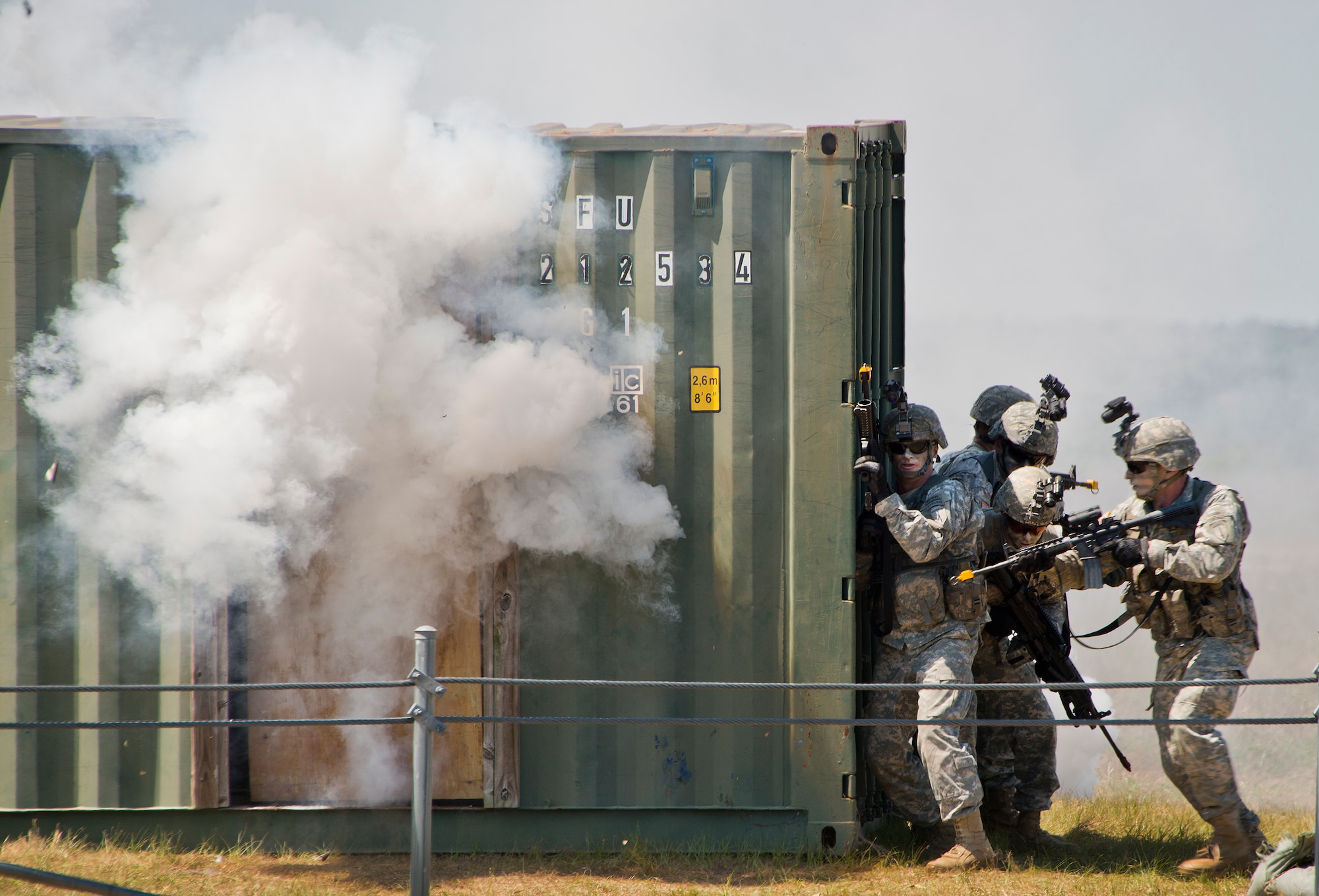 A Ranger fire team moves in to enter a building during a demonstration at the 6th Ranger Training Battalion’s open house event May 7 at Eglin Air Force Base, Fla.  The event was a chance for the public to learn how Rangers train and operate. The event displays showed equipment, weapons, a reptile zoo, face painting and weapon firing among others. The demonstrations showed off hand-to-hand combat, a parachute jump, snake show, and Rangers in action. (U.S. Air Force photo/Samuel King Jr.)