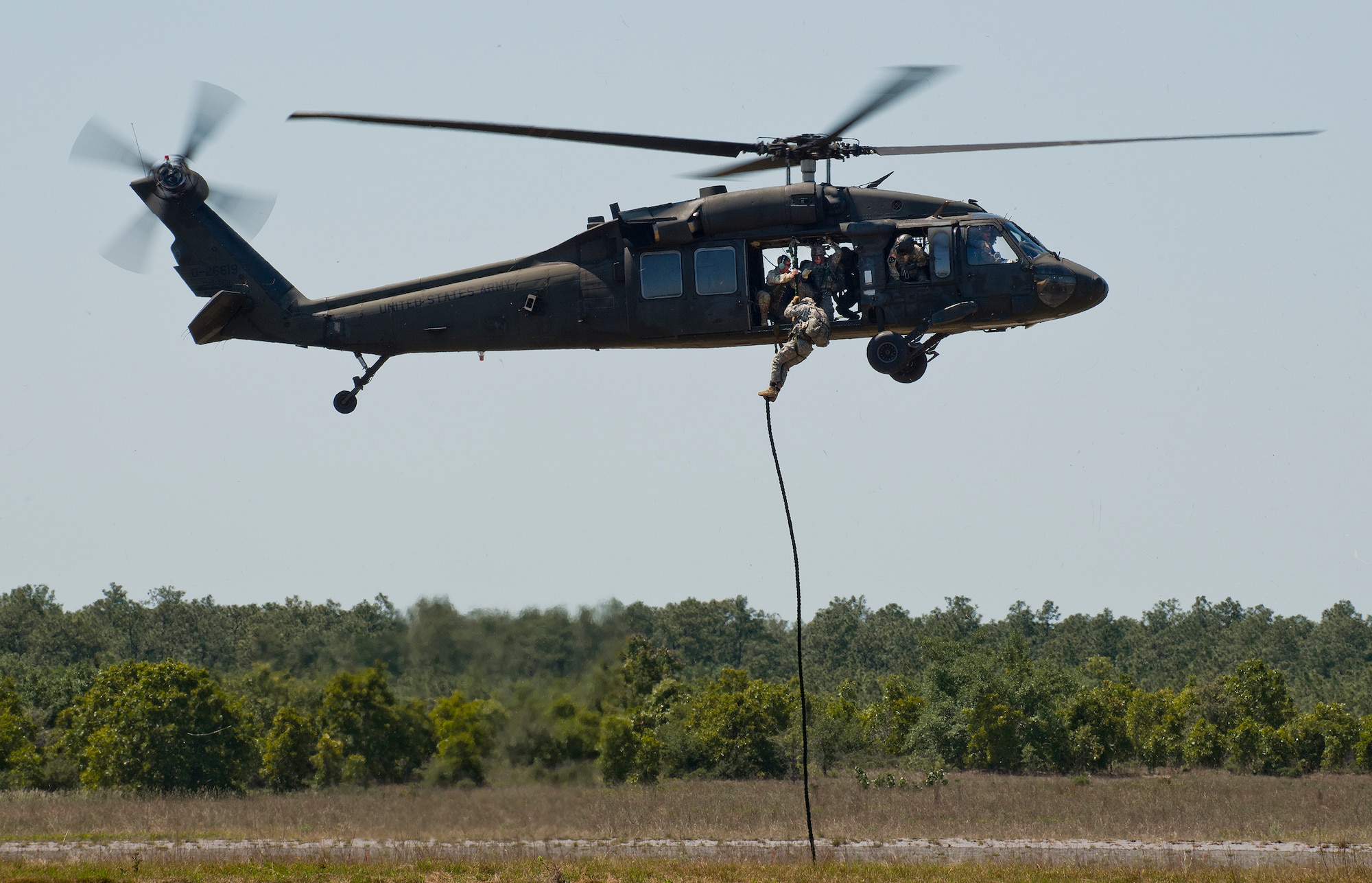 A Soldier exits a Blackhawk helicopter via a rope during a demonstration at the 6th Ranger Training Battalion’s open house event May 7 at Eglin Air Force Base, Fla.  The event was a chance for the public to learn how Rangers train and operate. The event displays showed equipment, weapons, a reptile zoo, face painting and weapon firing among others. The demonstrations showed off hand-to-hand combat, a parachute jump, snake show, and Rangers in action. (U.S. Air Force photo/Samuel King Jr.)