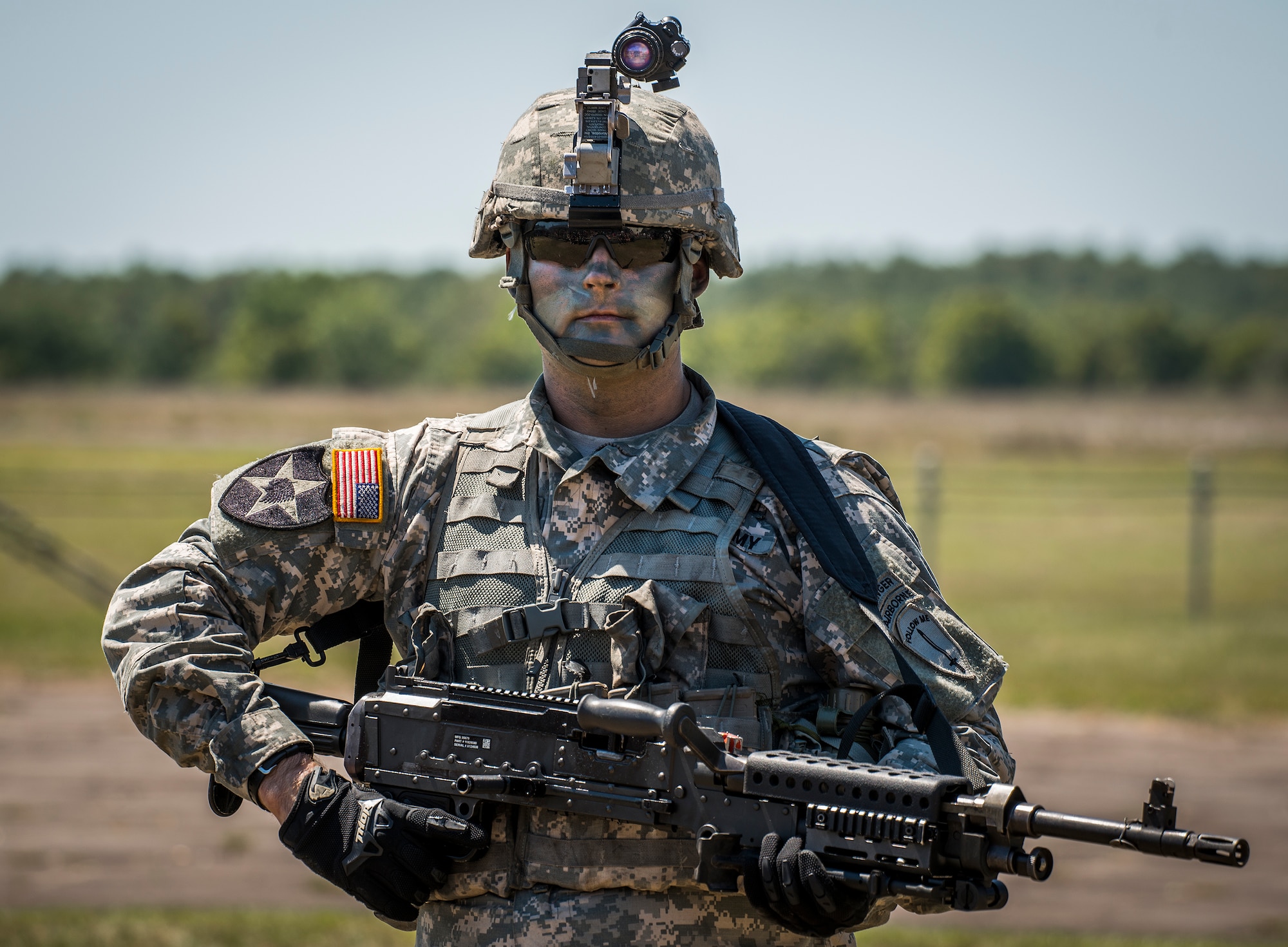 A heavy gunner stands with his team after a combat demonstration at the 6th Ranger Training Battalion’s open house event May 7 at Eglin Air Force Base, Fla.  The event was a chance for the public to learn how Rangers train and operate. The event displays showed equipment, weapons, a reptile zoo, face painting and weapon firing among others. The demonstrations showed off hand-to-hand combat, a parachute jump, snake show, and Rangers in action. (U.S. Air Force photo/Samuel King Jr.)
