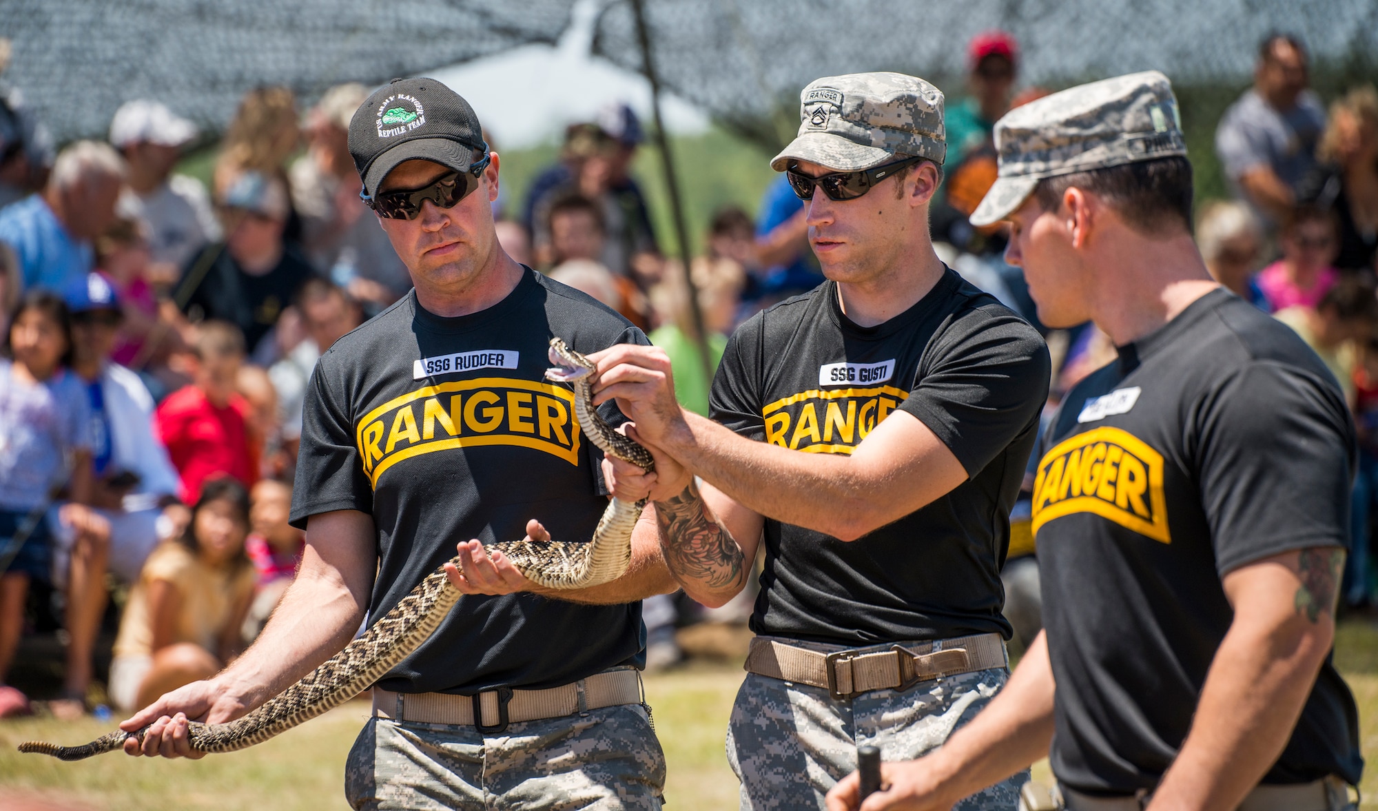 The 6th Ranger Training Battalion’s resident snake handlers show the fangs of a poisonous snake to the crowd during the snake show demonstration at the Rangers’ Open House event May 7 at Eglin Air Force Base, Fla. The event was a chance for the public to learn how Rangers train and operate. The event displays showed equipment, weapons, a reptile zoo, face painting and weapon firing among others. The demonstrations showed off hand-to-hand combat, a parachute jump, snake show, and Rangers in action. (U.S. Air Force photo/Samuel King Jr.)