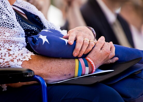 A relative of William Meadville holds a flag she received during the 47th Annual Explosive Ordnance Disposal Memorial Service at the Kauffman EOD Training Complex at Eglin Air Force Base, Fla., May 7. Meadville, who died in World War II, was one of six names of recent and past fallen EOD technicians added to the memorial wall this year.  The all-service total now stands at 320. (U.S. Air Force photo/ Samuel King Jr.)