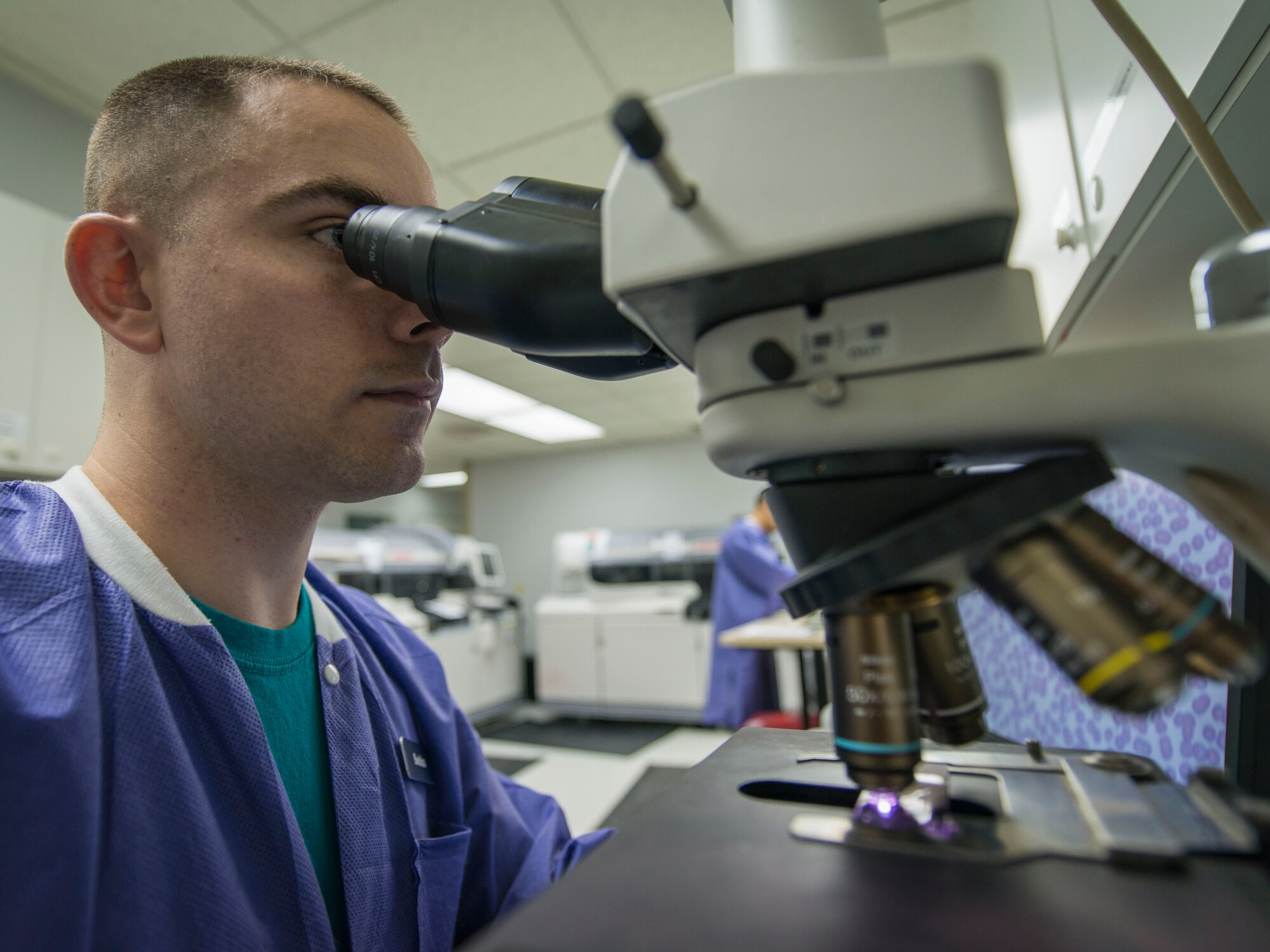 U.S. Air Force Tech. Sgt. Christopher Bedics, a laboratory technician with the 35th Medical Support Squadron, performs a quality check on a slide of blood at Misawa Air Base, Japan, February 19, 2016. To accurately inspect for cell abnormality and quantity, the blood is spread evenly across the slide’s surface and then placed underneath a microscope for observation. Bedics hails from Coopersburg, Pennsylvania. (U.S. Air Force photo by Staff Sgt. Benjamin W. Stratton)